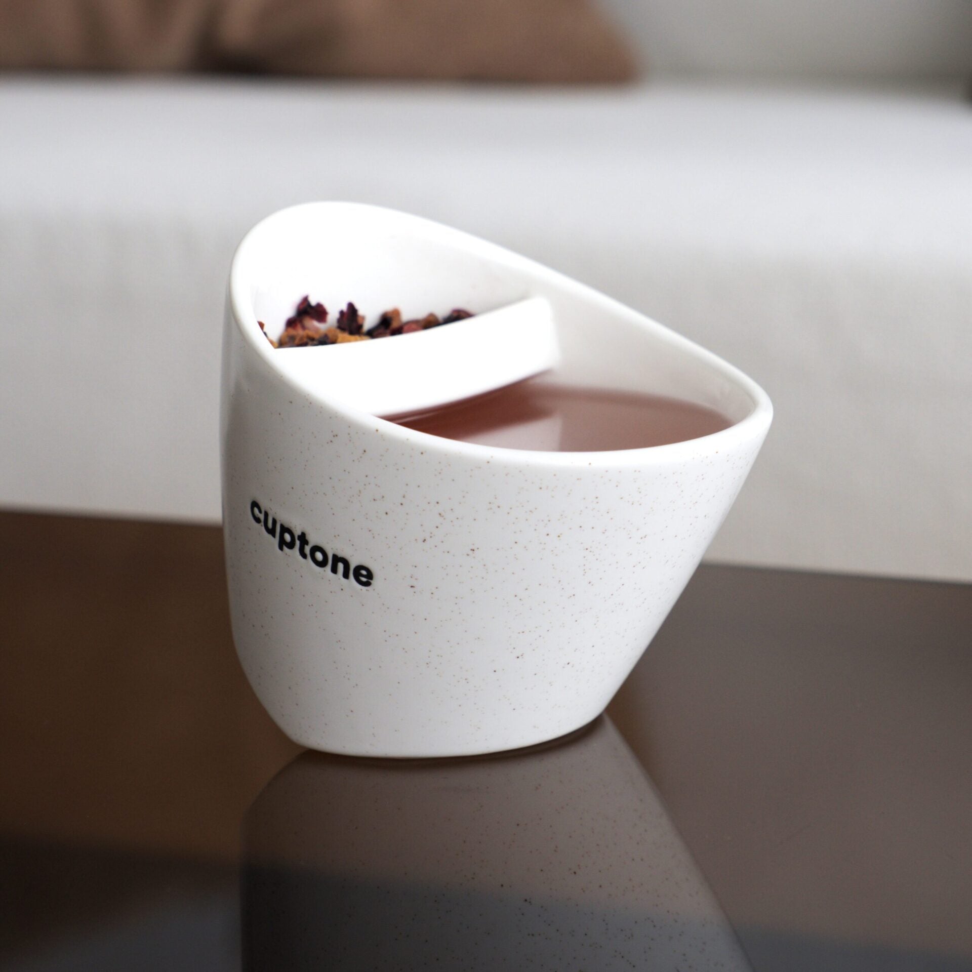 Cuptone teacup placed on a glass table surface